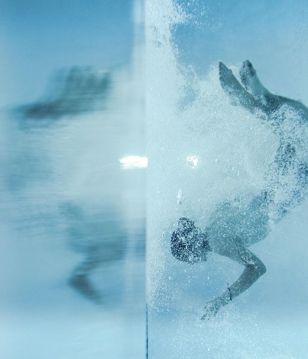 Person practicing a fluid movement in a bright, spacious room.